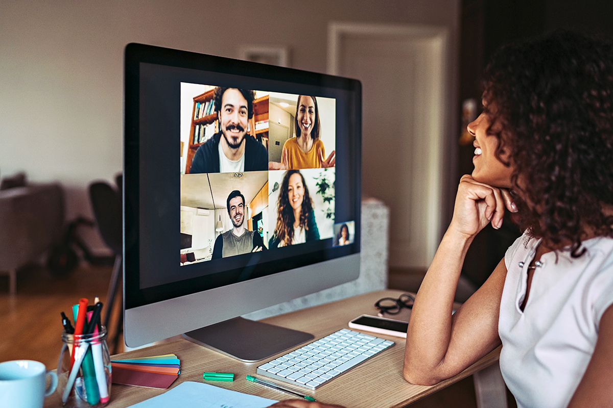 Person smiling at colleagues in a virtual meeting