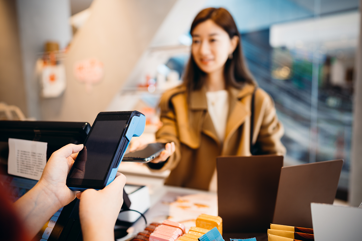 Woman paying using smart phone