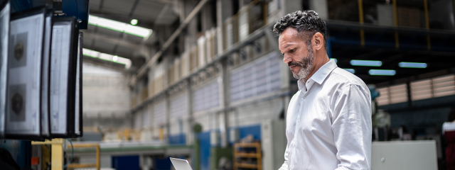 Man working at computer in a warehouse setting