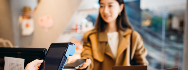 Woman making a retail payment with her smartphone